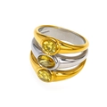 Macro shot of three stacked titanium steel rings featuring yellow zircon stones in gold and silver - Two-tone Gold Silver Yellow Zircon
