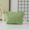 Close-up of green and white striped knit cosmetic bag with detailed woven texture - Green Stripe
