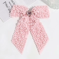 Detail of pink bow hair clip featuring faux pearls and a sparkling crystal center buckle - Pink