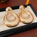 Close-up of vintage golden teardrop earrings in a black gift jewelry box - Gold