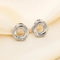 Macro shot of silver twisted hoop earrings with micro-pave zircons on silk fabric - Twisted Round Ring Style (KE116537-GC) / Steel