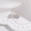 Detail shot of a S925 sterling silver bow charm bead encrusted with sparkling zircon stones - Large Bowknot (11.2x6mm) / Silver