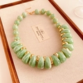 Macro detail of French vintage beaded necklace with light green marble resin teardrop beads - Green