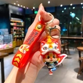 Schattige cartoon leeuwendans gelukskat sleutelhanger met rode polsband en gouden ring - B444-4 Zwart Stoffen Draak