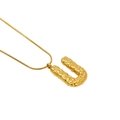 Hammered golden necklace with letter U pendant in minimalist lava texture design - Letter U