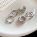 Detailed view of five silver geometric irregular rings on a white ceramic plate - Silver Irregular Geometric Style (Set of 5)