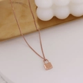 Minimalist 18k rose gold plated padlock pendant necklace on elegant stone display - Style C - Concave Lock / Rose Gold