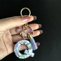 Detailed view of resin letter Q keychain with purple butterfly and glitter heart sequins - Letter Q / Butterfly Tassel 8-Shape Buckle