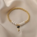Golden bead and pearl bracelet featuring a black heart-shaped key pendant on silk - Enamel Heart Key Pendant Set (E000410YS)