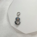 Detail view of a S925 silver owl charm with dark grey enamel and rhinestone heart inlay - Style H (Owl)