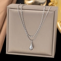 Detail of silver double layer necklace featuring a polished water drop pendant on a jewelry box - Double Layer Water Drop / Steel
