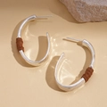 Detail of C-shaped geometric earrings with brown leather wrap on a stone base - Silver (Silver Pin)