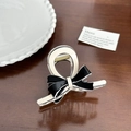 Elegant black and white acetate bow hair claw clip displayed on a dark wooden surface - White Base Ribbon Small-8cm