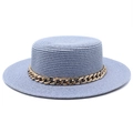 Detail view of a blue straw flat top hat featuring a chunky gold chain and woven texture - Sky Blue