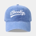 Close-up of light blue washed cotton baseball cap featuring white Brooklyn embroidery - Adjustable / Light Blue