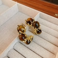 Detail view of gold claw-set brown tiger eye C-shaped hoop earrings on a light background - C-Shaped Half Round Claw Setting (34#)