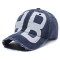 Navy blue washed denim baseball cap with distressed brim and white letter graphics - Navy Blue