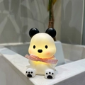 Glow panda night light with pink bow ribbon and warm yellow ambient lighting - Cool Bear Blue Ribbon