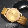 Gold minimalist mesh strap watch displayed on blue leather wallet with a modern sleek design - Gold