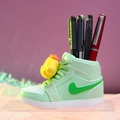 Green sneaker pen holder with yellow duck figurine and writing pens on pink background - Yellow Sneaker Pen Holder (979-3 Yellow Dog)