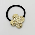 Elastic black hair tie featuring a golden textured clover-shaped metal charm - Matte Gold - Textured Clover