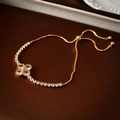 Macro detail of gold-plated clover bracelet with sparkling zircons and adjustable slider clasp - Gold Four Leaf Clover Zircon Bracelet