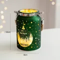 Detail of green frosted glass Christmas lantern with golden reindeer and forest motifs - Glowing Lantern - Green