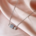 Exquisite silver key lock pendant necklace with sparkling zircons on pink silk background - Silver