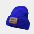 Detailed view of Klein blue knit beanie featuring a brown fabric patch and soft texture - Sapphire Blue
