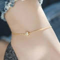 Minimalist gold titanium anklet featuring a brilliant cubic zirconia solitaire pendant - Anklet / Gold