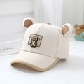 Detailed close-up of a beige kids baseball cap featuring cute plush bear ears and a patch - 52cm (2-5 Years) / Off White
