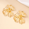 Chunky gold metal flower earrings with white pearl centers in 100-character detail - Gold
