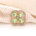 Macro shot of green marquise clover charm with crystals on gold plated metal base - Grass Green
