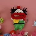 Handmade crochet sausage lip key cover in green with striped pattern and yellow bag charm - Green Christmas with Braids