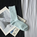 Light blue ribbed cotton blend crew sock presented flat on styled magazine background - Short Ice Blue