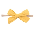 Detail of yellow textured bow headband on a beige elastic nylon strap for babies - Yellow(17)