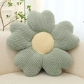 Sage green flower-shaped corduroy cushion with beige center on a soft plush sofa - Blue