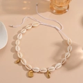 Detail of adjustable white shell necklace with gold seahorse and seashell pendants - White Rope Conch Necklace