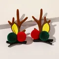Detail shot of Christmas deer antler hair clips with plush pom-poms and velvet texture - Christmas Antler Hair Clips - Red Green Pom Coffee