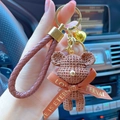 Brown resin bear keychain with knitted texture and leather rope on car background - Full Set (With Woven Rope + Bell) / Brown