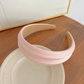 Chic pink wide-brimmed PU leather headband displayed on a ceramic decorative plate - Light Pink Sponge Headband