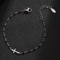 Detail of stainless steel beaded cross bracelet on a premium black textured surface - Silver-Black