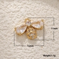 Macro view of gold-plated bee charm with white shell and zircon, size 15mm x 11mm - Zirconia Bee