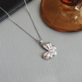 Close-up of a silver butterfly pendant necklace with shimmering zircon stones and fine chain - Bowknot Necklace-Silver 0384Y