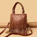 Brown Bohemian tassel handbag with gold metallic circular handles and a long shoulder strap - Brown