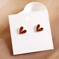 Chic heart-shaped earrings in amber red with golden beaded trim on display card - Champagne