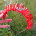 Detailed shot of red crystal wizard crown with silver hollow moon on grass background - Orange Red + White K Moon