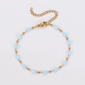 Macro view of golden stainless steel chain with light blue faceted beads and lobster clasp - Blue Rectangle