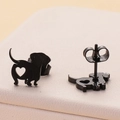 Macro view of black stainless steel dachshund earrings with hollow heart detail - Black