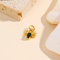 Macro detail of a gold spider pendant with a black oval gemstone for DIY jewelry making - Black